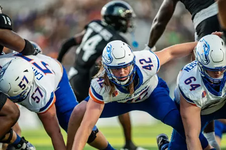 Mason Hutton blocking after a long snap at Hawai'i