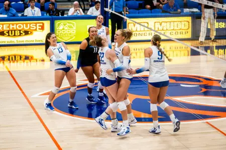 Team, dressed in white, celebrates a point during the UC San Diego match on Sept. 4.
