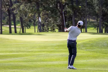 Cole Rueck watches the result of his golf swing