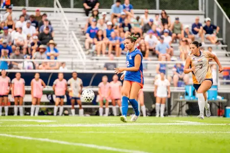 Teryn Newkirk, in a blue jersey, looks for a pass.