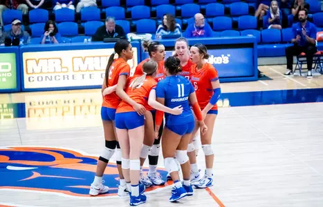 Broncos, wearing orange jerseys, huddling on the floor in Bronco Gym during the Arizona match on Sept. 5, 2025.