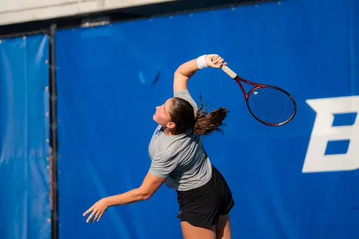 Carla Grignac hitting a serve