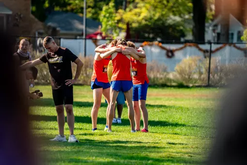 Men's cross country team huddling