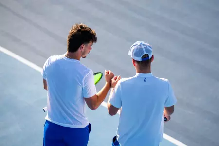 Two men's tennis players talking