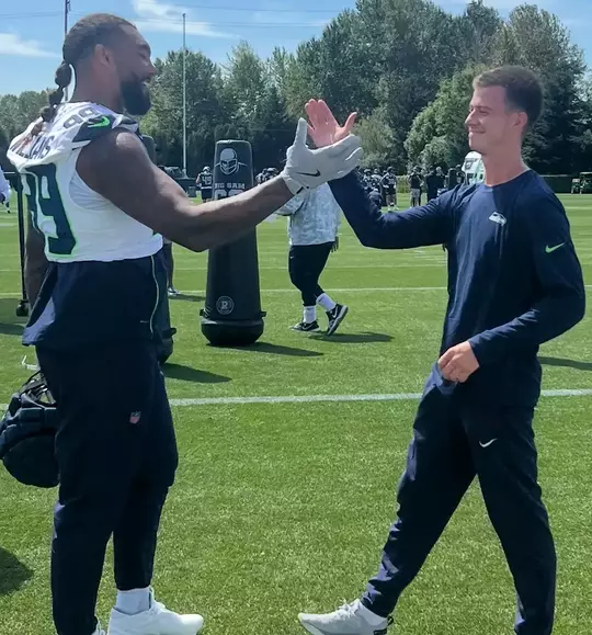 Easton Hudson dapping up Leonard Williams