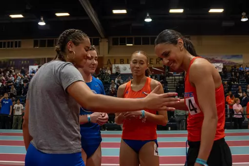 Members of the women's track and field team in a huddle