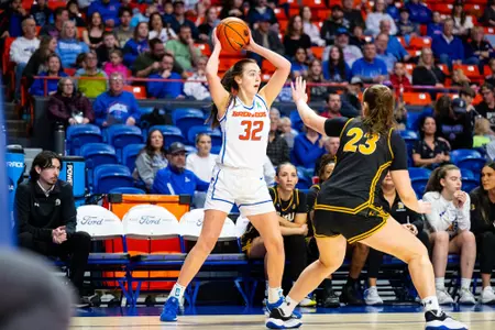 Natalie Pasco passing the ball.