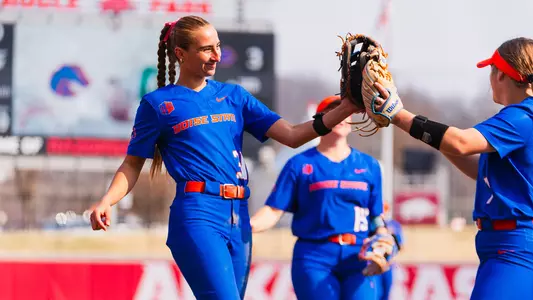 Hollie Farmer and Kate Penberthy celebrate using their gloves for a high five.