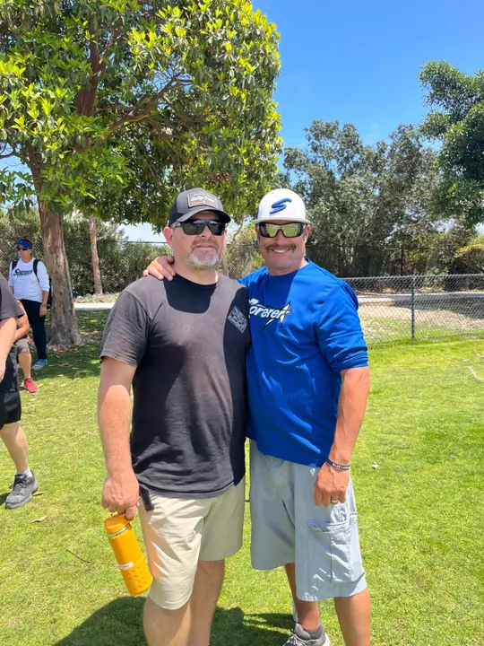 Stan Flindt and Brandan Everett embrace for a photo.