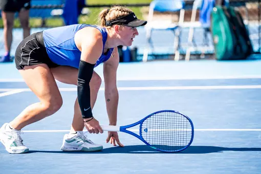 Paula Schaefer bending down under a serve