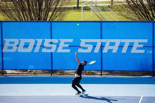 Carson Baker serving the ball.