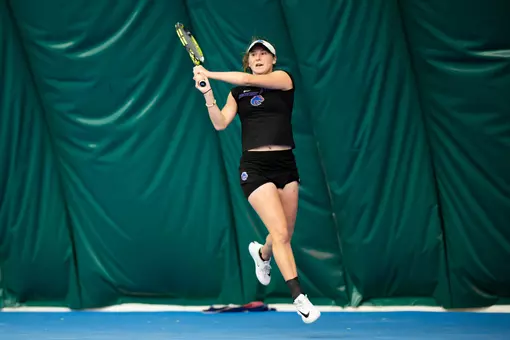 Allison Isaacs following through her backhand shot