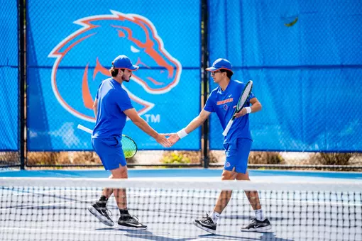 Carson Baker and Avery Tallakson giving each other a high five.
