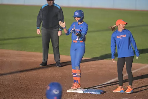 2026 Holie Farmer standing on first base clapping her hands.