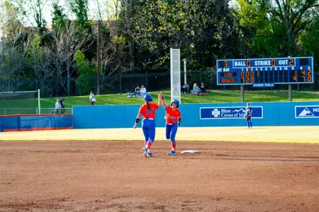 Quinn Southerland and Jorja Crider high five at second base.
