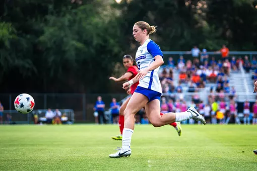 Mia Lane running after the ball.
