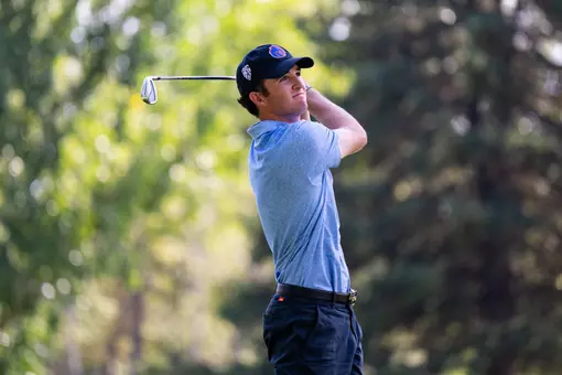 Luke Cushman watches the flight of the ball following a swing during a practice round