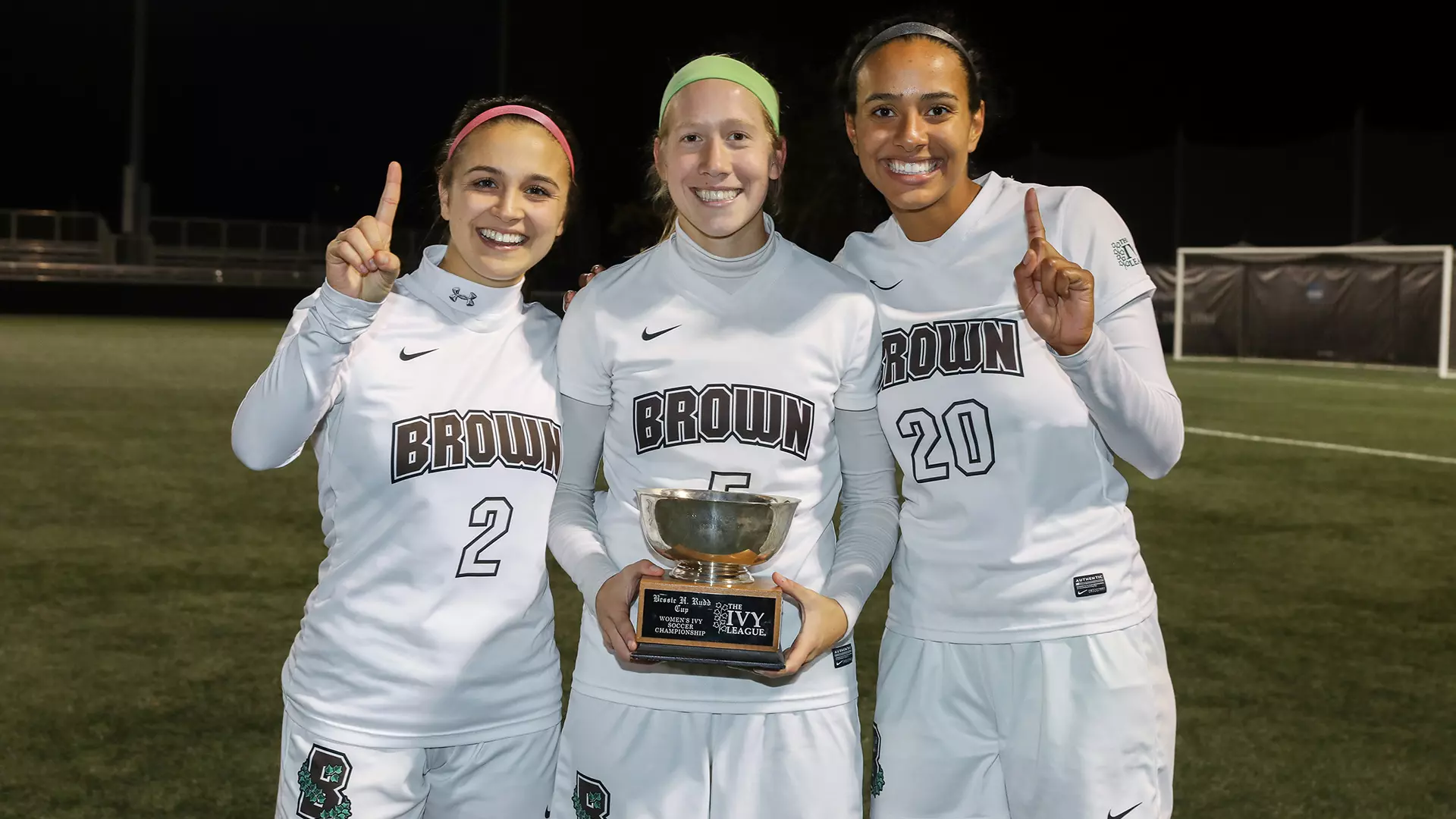Celia Story (left) and fellow captains Abby Carchio and Sydney Cummings celebrate the Ivy League championship.