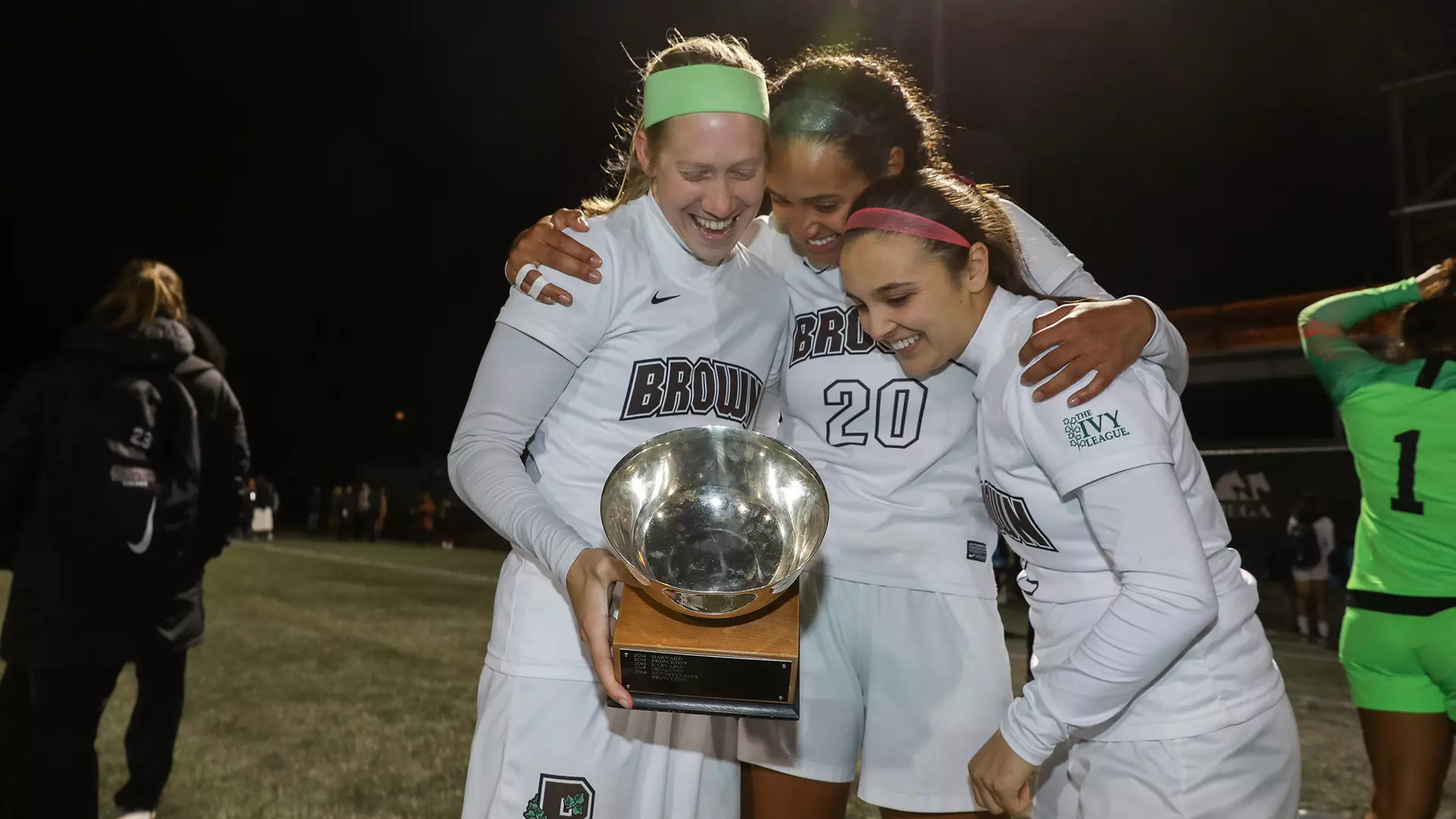 Celia Story (right) and fellow captains Abby Carchio and Sydney Cummings celebrate the Ivy League championship.