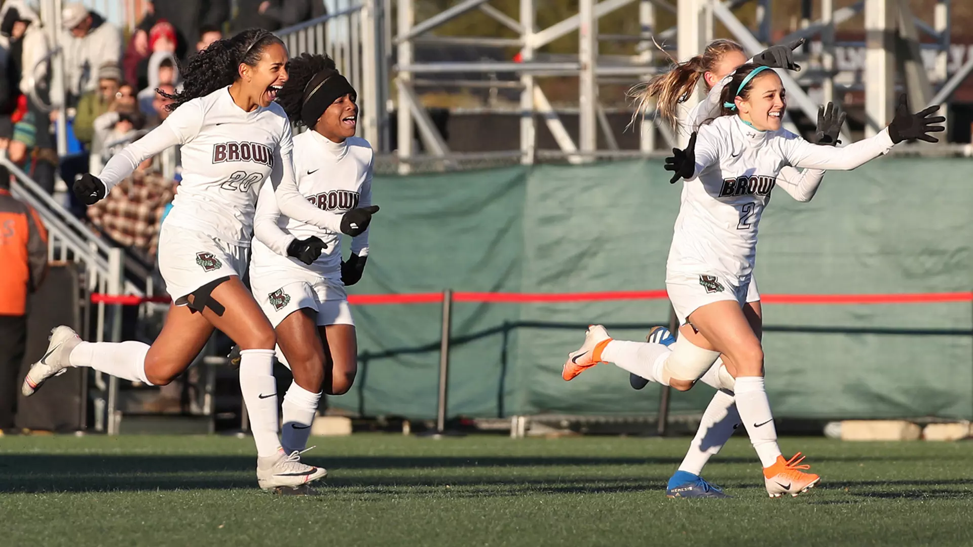 Celia Story (right) and teammates celebrate the winning penalty kick against Monmouth.