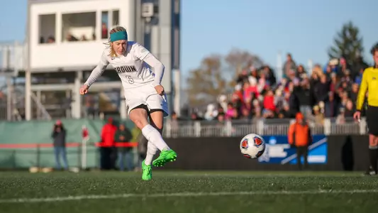 Abby Carchio takes a penalty kick with a packed crowd watching