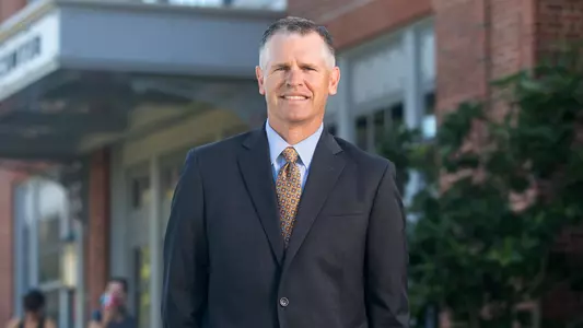 Jack Hayes poses for a portrait outside the Nelson Fitness Center on a sunny day
