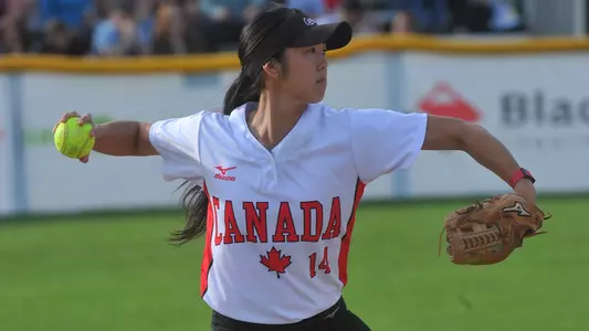 Janet Leung looks to throw to first base while competing for Softball Canada