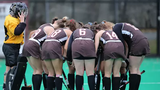 Photo of a team huddle for field hockey