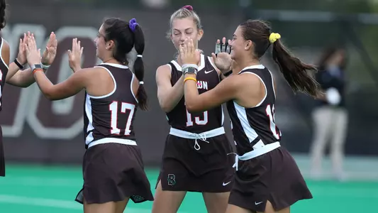 Teammates high-fiving each other before a field hockey game