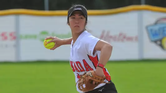 Janet Leung looks to throw to first base while competing for Softball Canada