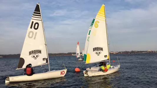 Brown sailors work together on a sunny day