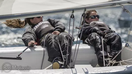 Brown sailors work together on a sunny day