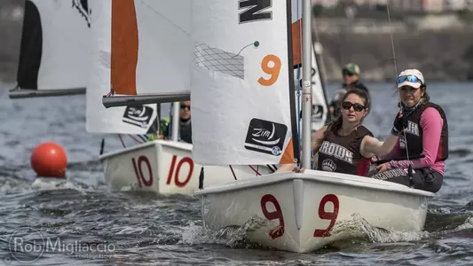 Brown sailors work together on a sunny day