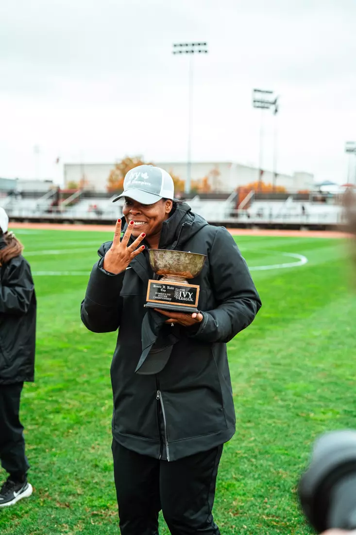 Head coach Kia McNeill throws up her four after winning her fourth consecutive Ivy League Championship on Saturday at Cornell.
