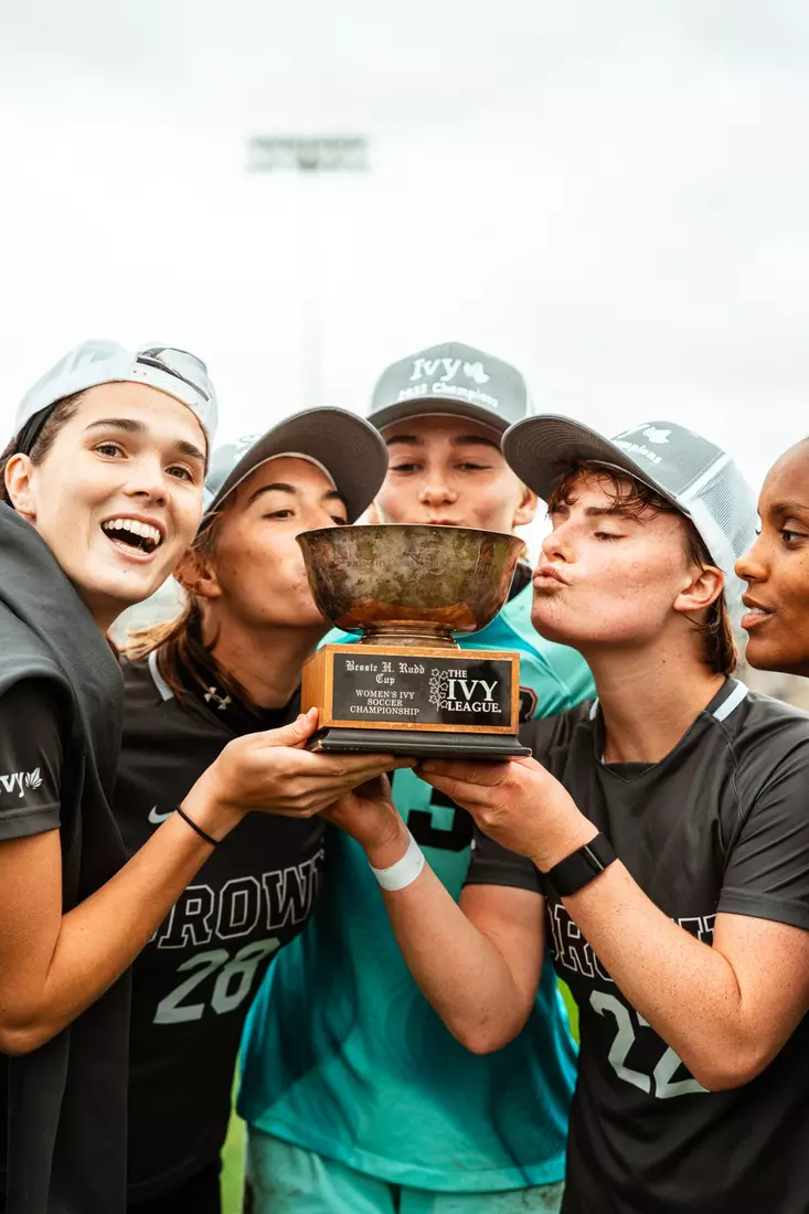 Seniors kiss the championship trophy on Saturday, October 21 at Cornell