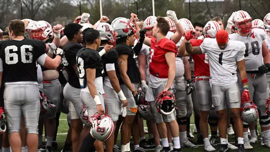 Team huddles after spring practice on April 11, 2023