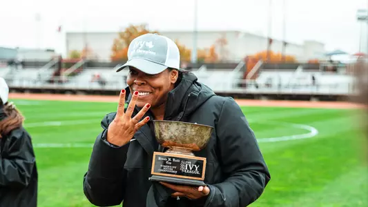 Kia McNeill holds trophy after 4-peat
