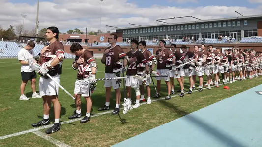 The Brown men's lacrosse team standing for the national anthem at UNC (Mar. 7, 2026)