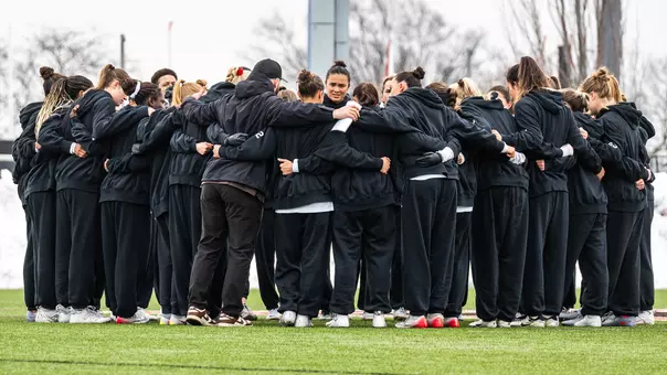 The Brown women's lacrosse team huddling