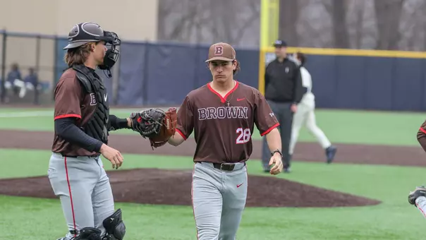 Dylan Reid fist bumps Jack Edmunds walking off the mound