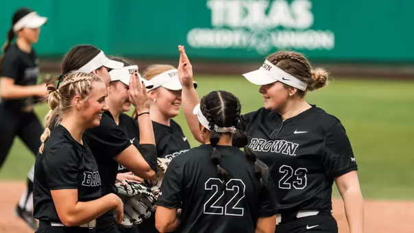 Brown softball huddle at Texas State