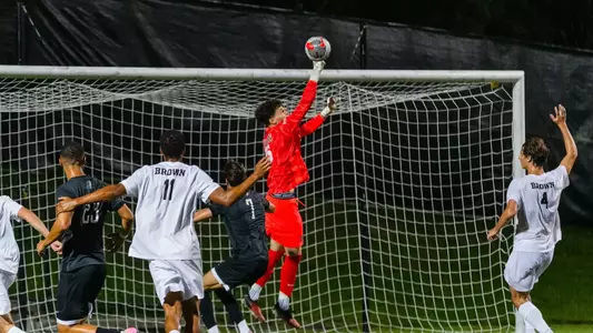 Max Pfaffman punches the soccer ball away