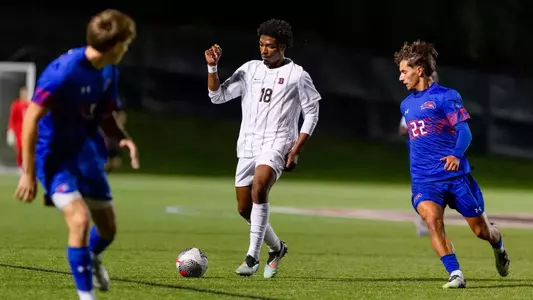 Zion Wharton passes the soccer ball