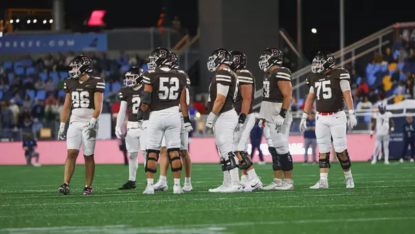 Football Huddle Against Rhode Island