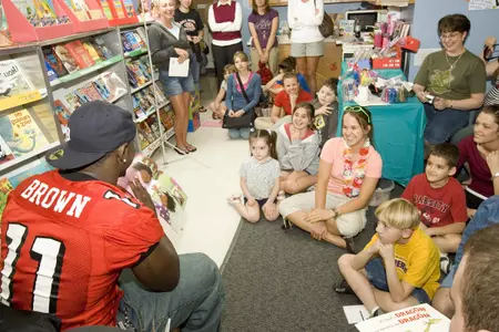 Football Players Assist with Read-A-Thon