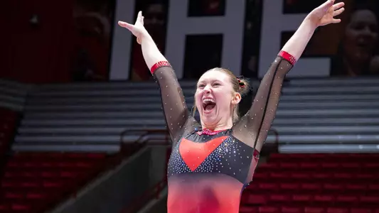 Ashley Szymanski celebrates on beam versus Bowling Green