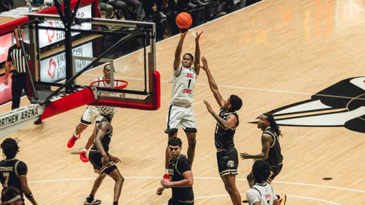 Trey Lewis in a white Ball State basketball uniform shooting a jumper