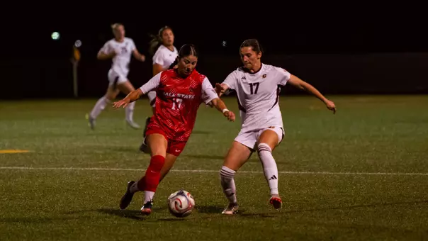 Mary Jane Keller dribbles the ball against a defender