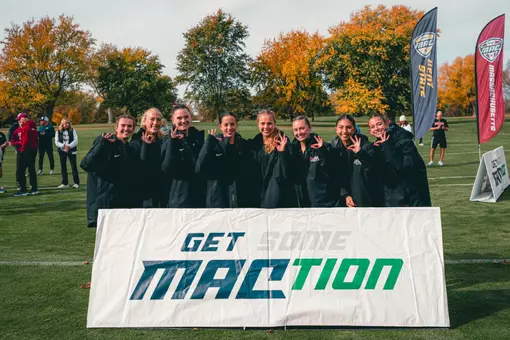 The Ball State Cross Country Team poses with a MAC sign after the 2026 MAC Championships.