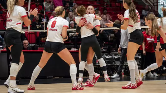 Elizabeth Tabeling celebrates an overpass kill with her teammates in the Oct. 6 match versus Miami